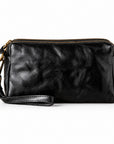 Black leather wristlet pouch with gold-tone hardware and a top zipper.