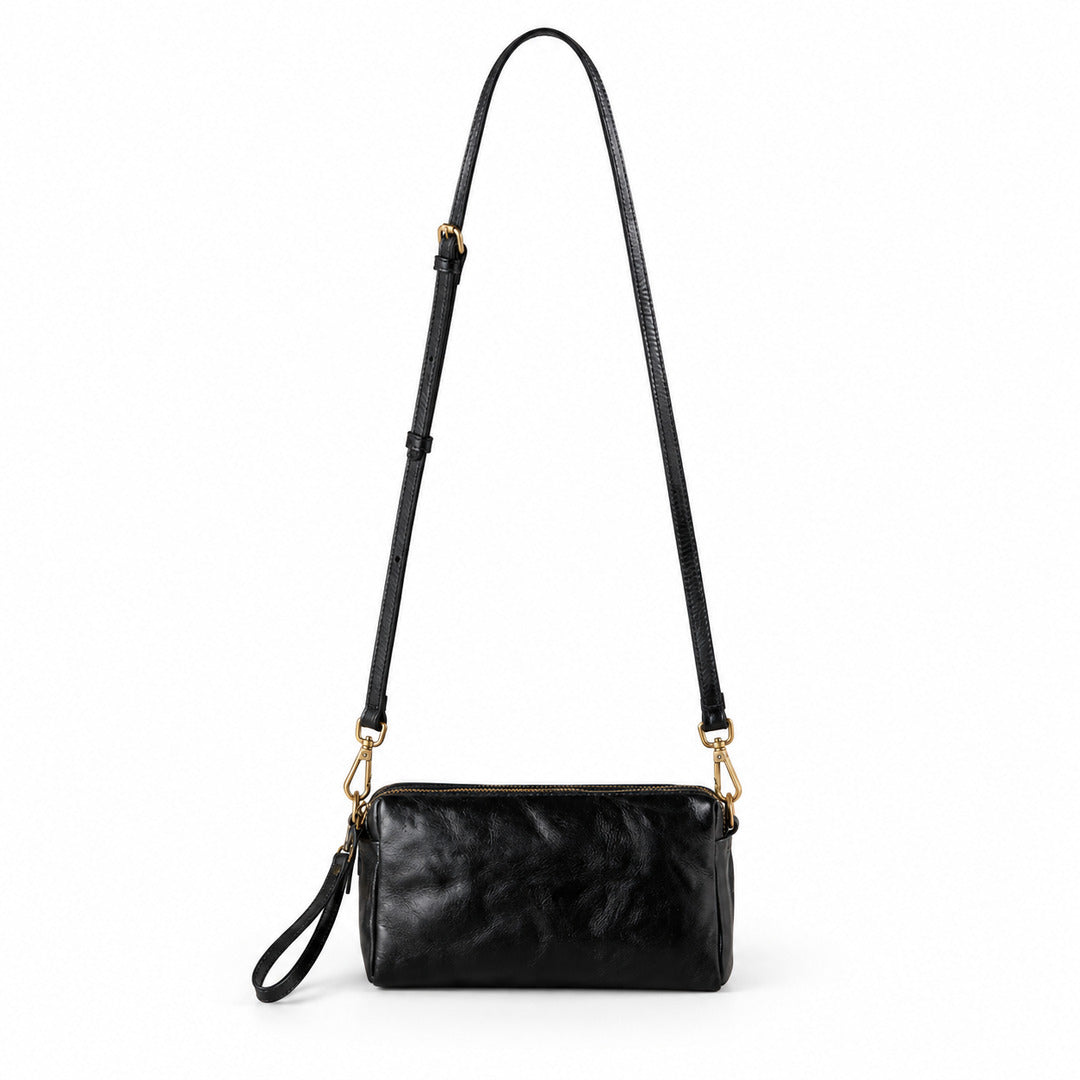 A black leather crossbody bag with a long shoulder strap, gold-tone hardware, and a wristlet loop.