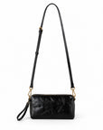 A black leather crossbody bag with a long shoulder strap, gold-tone hardware, and a wristlet loop.