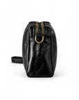 Black leather crossbody bag with gold-tone hardware, shown from the side profile.