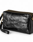 Black leather crossbody pouch with gold-tone hardware and a wrist strap, shown.