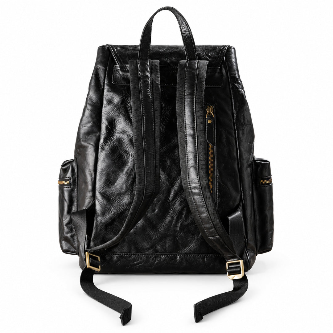 Black leather backpack with gold-tone hardware, shown from the back on a white background.
