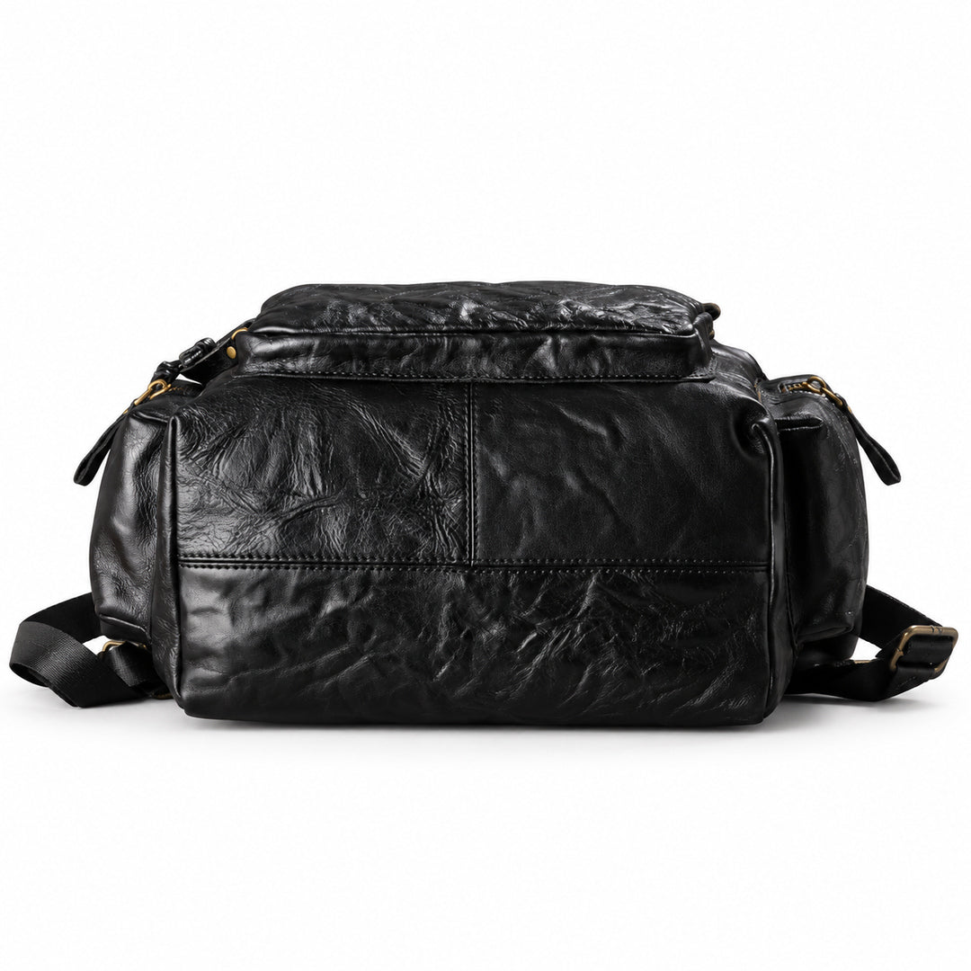 A black crinkled leather shoulder bag with gold-tone hardware, shown from the front against a plain white background.