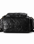 A black crinkled leather shoulder bag with gold-tone hardware, shown from the front against a plain white background.