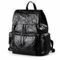 A black crinkled leather backpack with gold-tone hardware, shown on a clean white background.