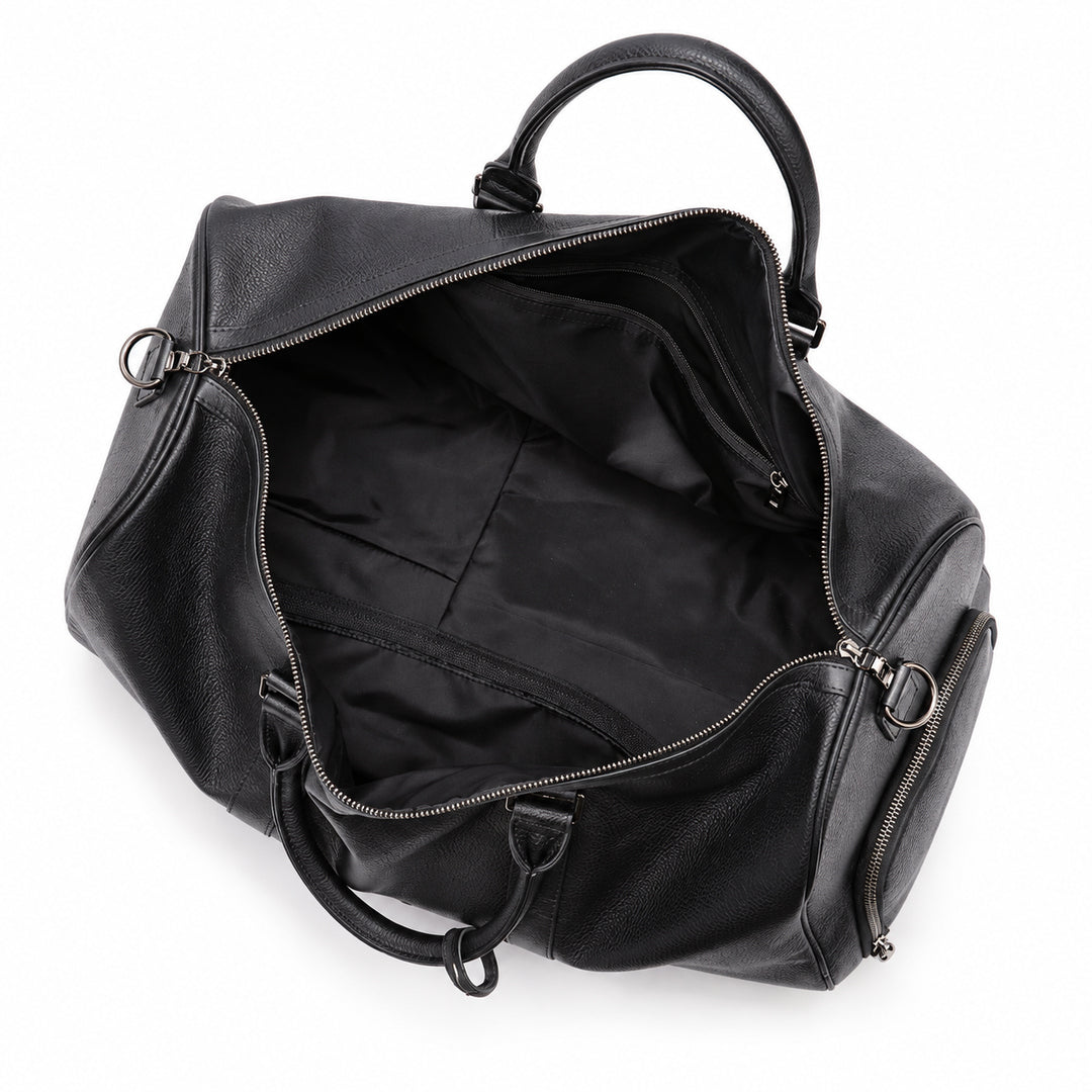 A black pebbled leather duffel bag shown open from an overhead angle, revealing a black fabric interior with zippered compartments and dual top handles on a white background.