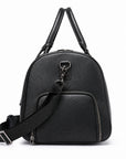 A black pebbled leather backpack with dual top handles, a front zippered pocket, and an adjustable shoulder strap, shown on a plain white background.
