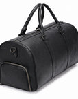 A black pebbled leather duffel bag with dual top handles, a front zippered pocket, and a zippered main compartment, shown on a white background.