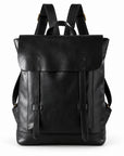 A black leather backpack with a front flap, buckle straps, and top handles.