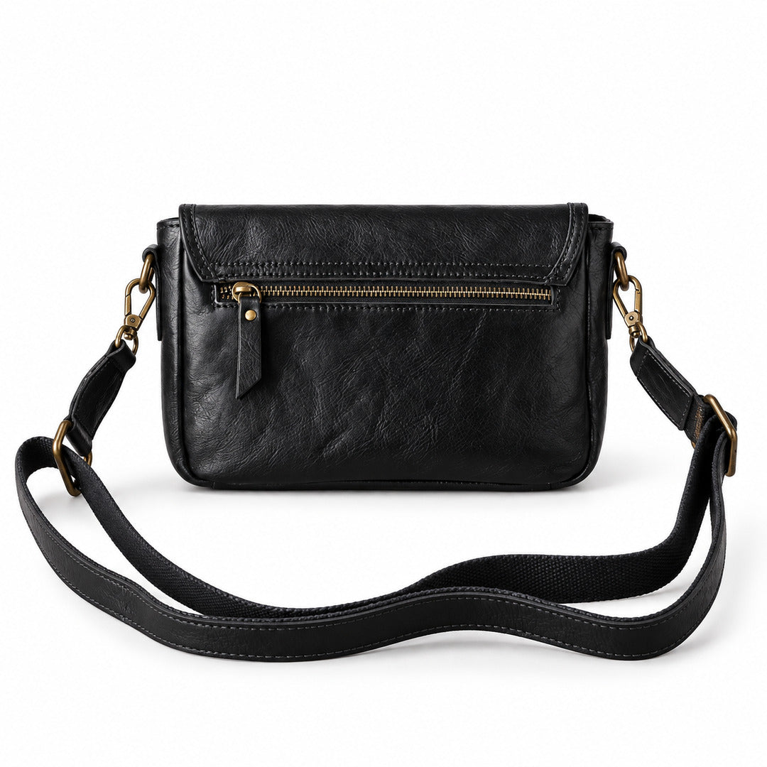 Black leather crossbody bag with a front zip pocket and a long adjustable shoulder strap.