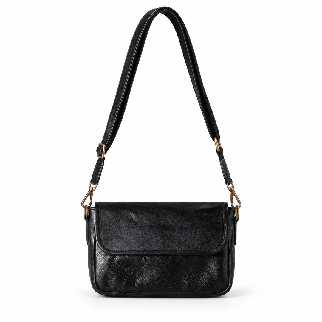 A black leather crossbody handbag with a front flap and an adjustable shoulder strap.