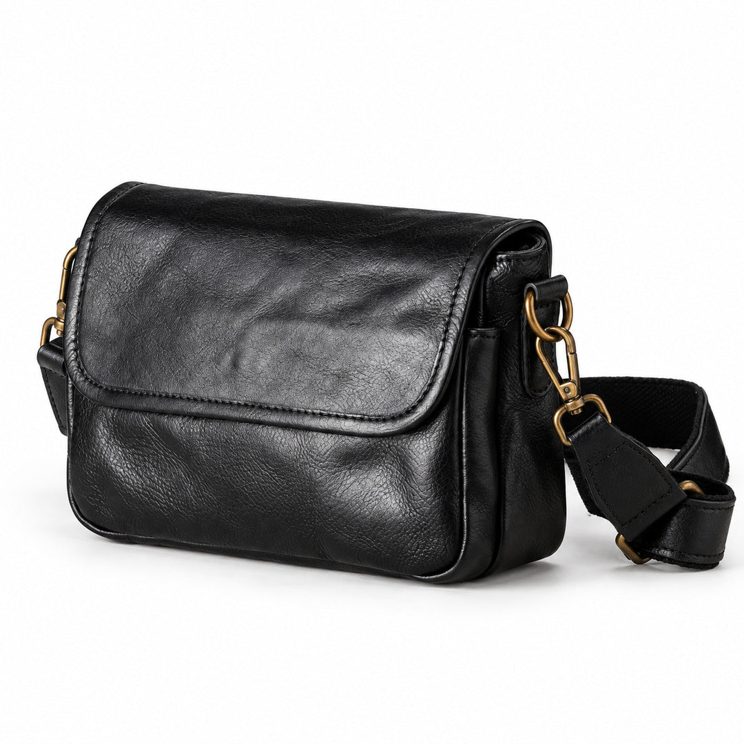 Black leather crossbody bag with gold-tone hardware and a detachable shoulder strap.