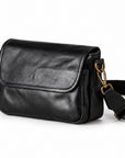 Black leather crossbody bag with gold-tone hardware and a detachable shoulder strap.