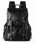 A black distressed leather backpack with gold-tone buckle details.
