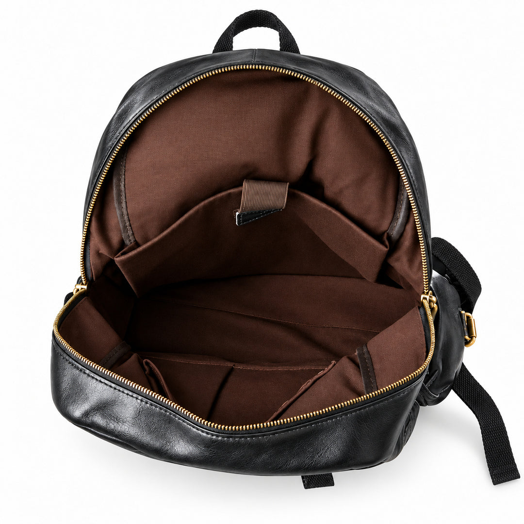 Open black leather backpack showing a brown fabric interior with gold-tone zippers and internal pockets.