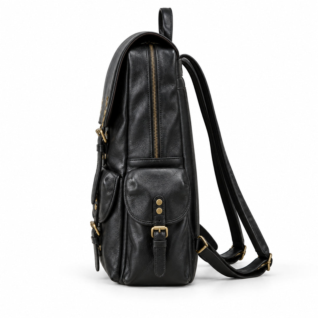 A black leather backpack shown from the side profile against a clean white background, featuring gold-tone hardware and a long shoulder strap.