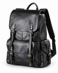 A black leather backpack with gold-tone hardware, featuring a front flap with buckle straps, a main zippered compartment, and a side pocket.