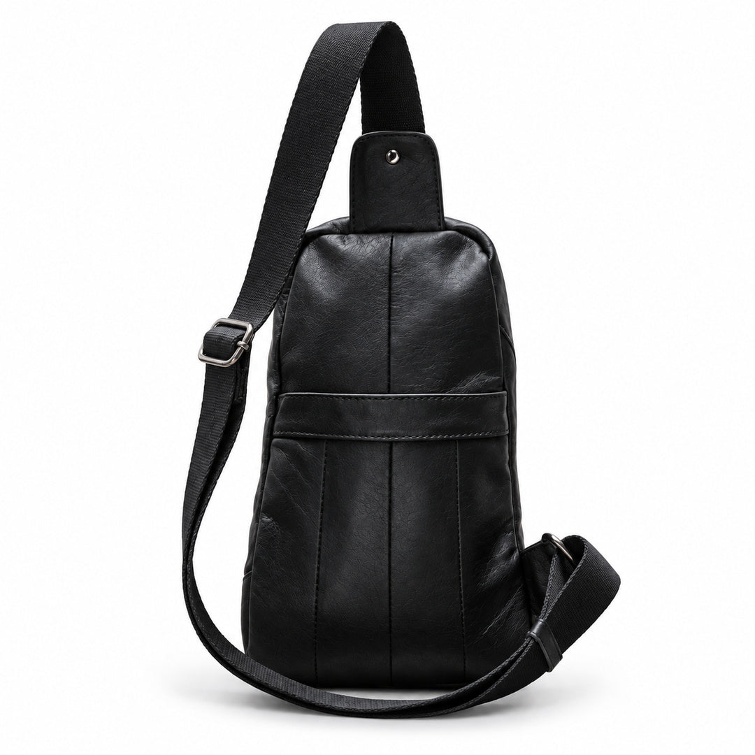 Back view of a black leather sling bag showing the rear slip pocket and adjustable strap.