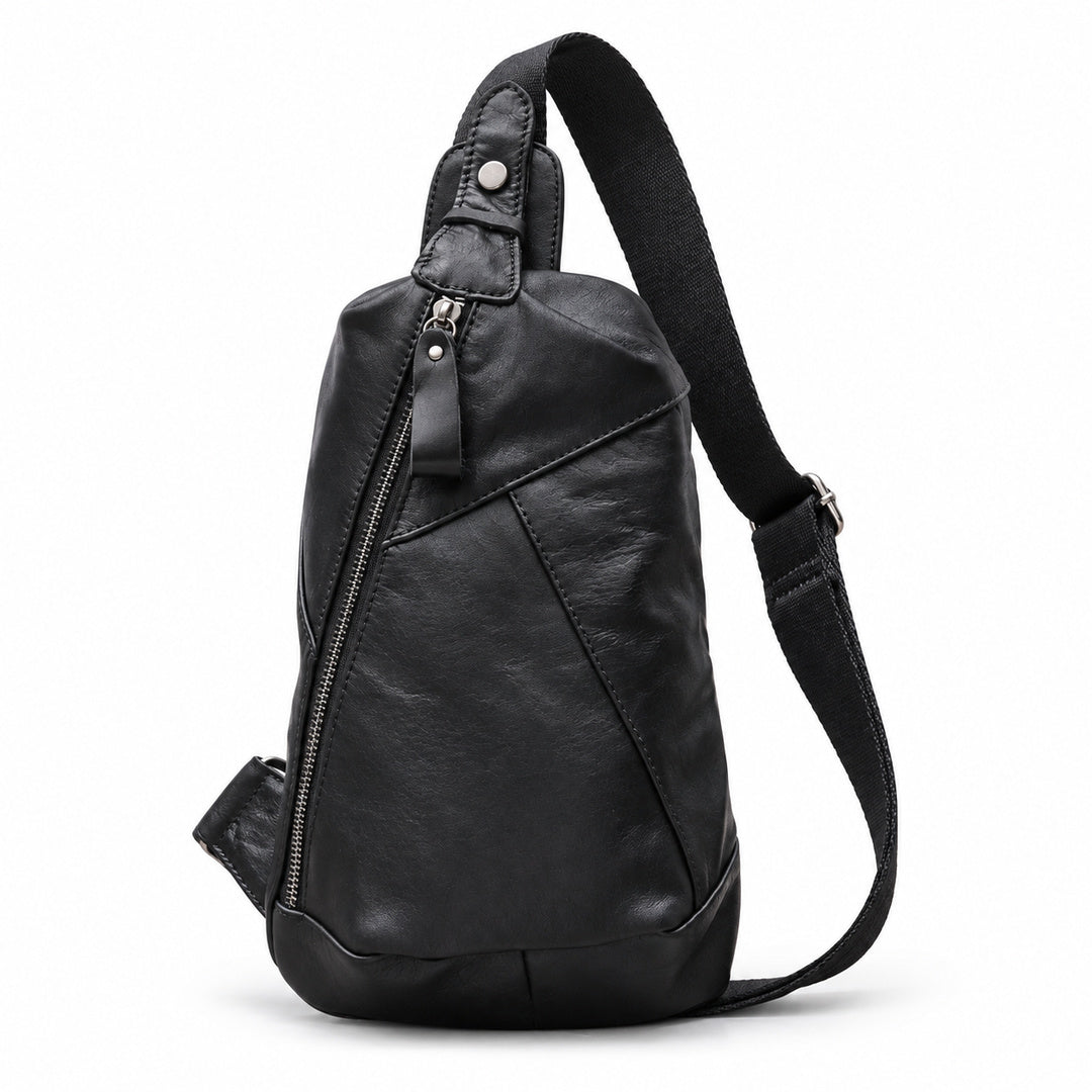 Black leather sling bag with a diagonal zipper, stitched front panels and a single shoulder strap.