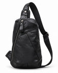 Black leather sling bag with a diagonal zipper, stitched front panels and a single shoulder strap.