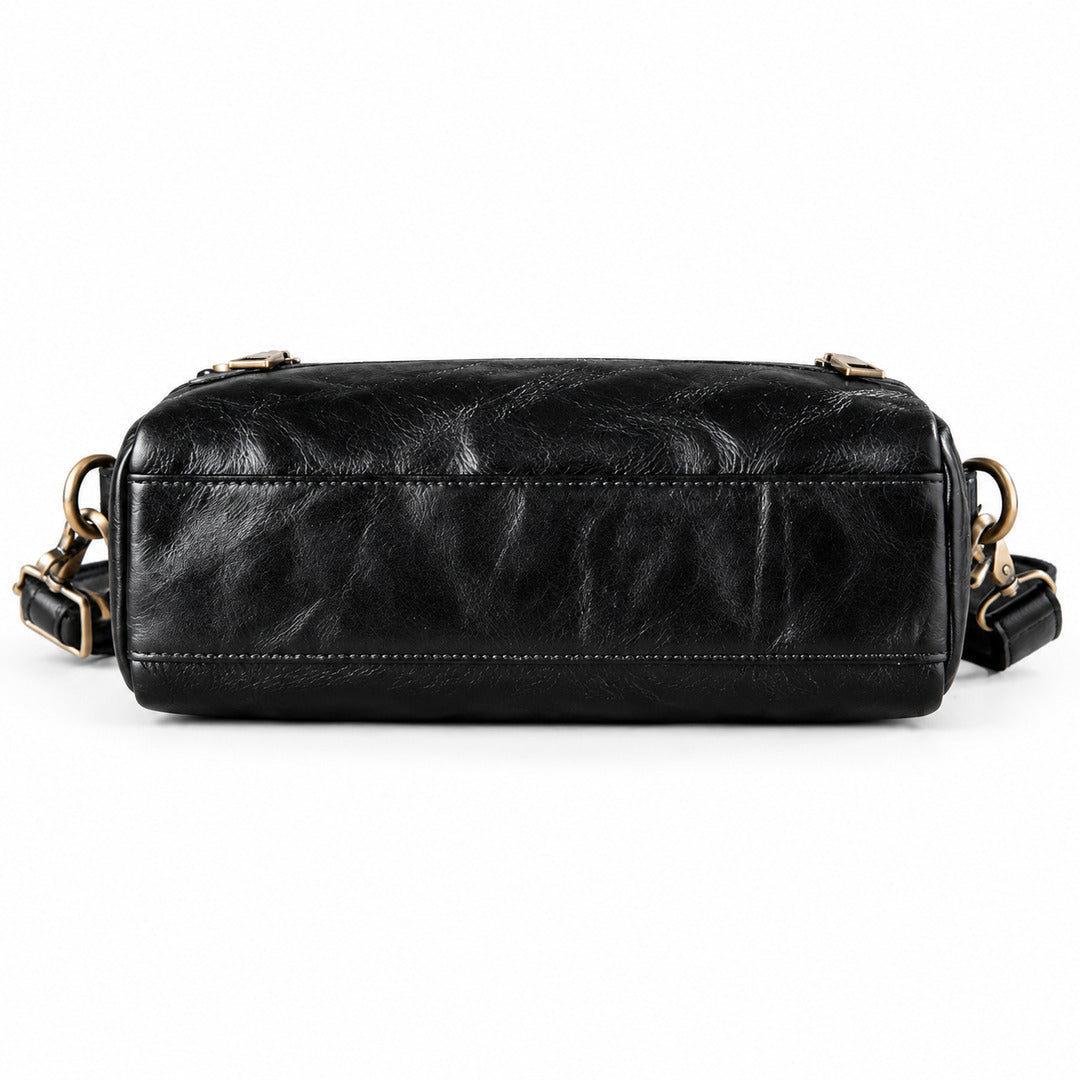 A black leather shoulder bag with a rectangular shape, featuring gold-tone hardware and a matching black leather strap.