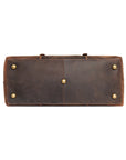 Bottom view of vintage leather duffle bag with protective brass studs, ensuring durability and premium quality