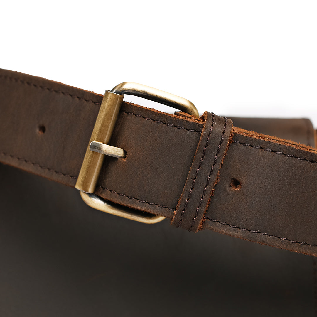 Detailed close-up of brass buckle and stitching on a premium leather strap for timeless durability