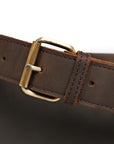 Detailed close-up of brass buckle and stitching on a premium leather strap for timeless durability