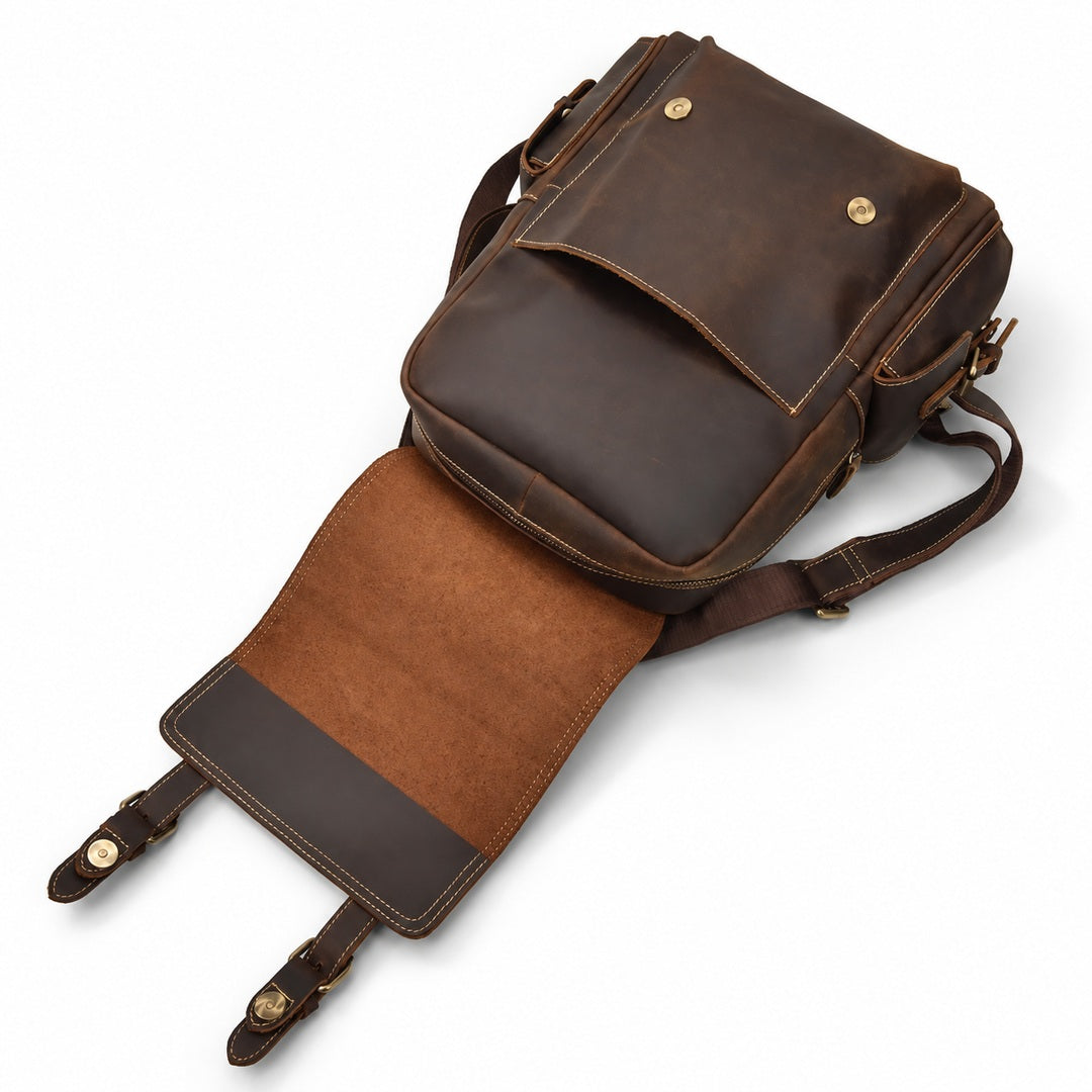 A dark brown leather messenger bag with a front flap pocket and a detachable shoulder strap.