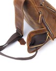 Brown leather bag with a strap on a white background
