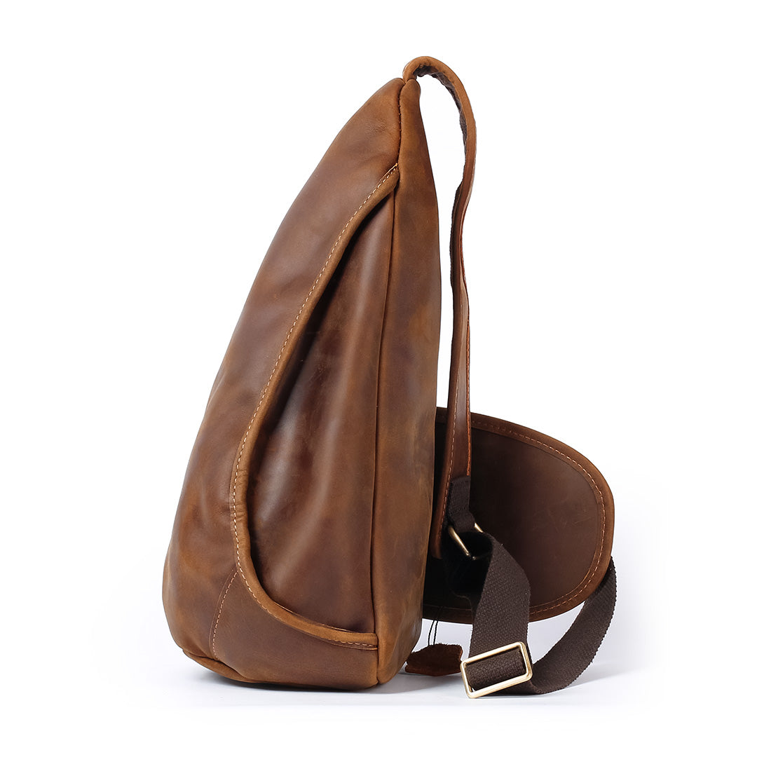 Brown leather sling bag on a white background