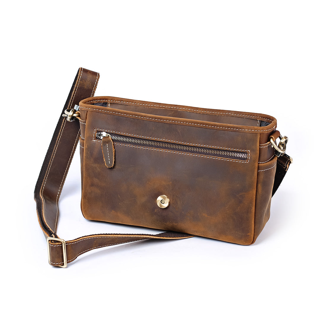 Brown leather crossbody bag on a white background