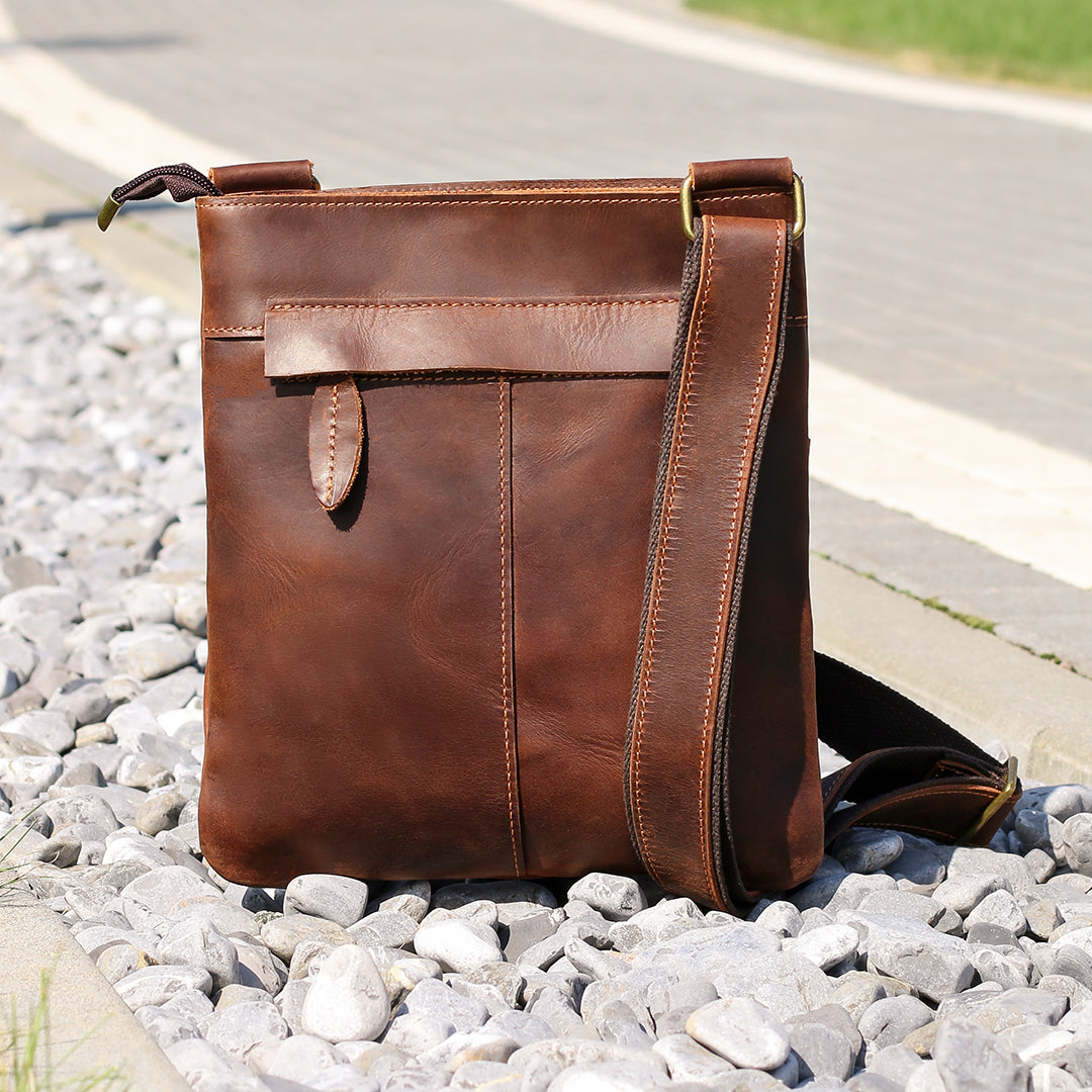 Back view of a brown Crazy Horse leather crossbody bag, showcasing its sleek design and adjustable strap.