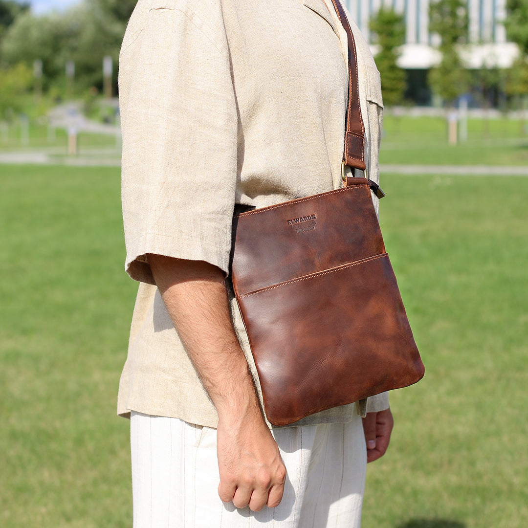 Stylish man wearing a premium brown Crazy Horse leather crossbody bag, showcasing its practical and vintage-inspired look.