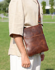 Stylish man wearing a premium brown Crazy Horse leather crossbody bag, showcasing its practical and vintage-inspired look.