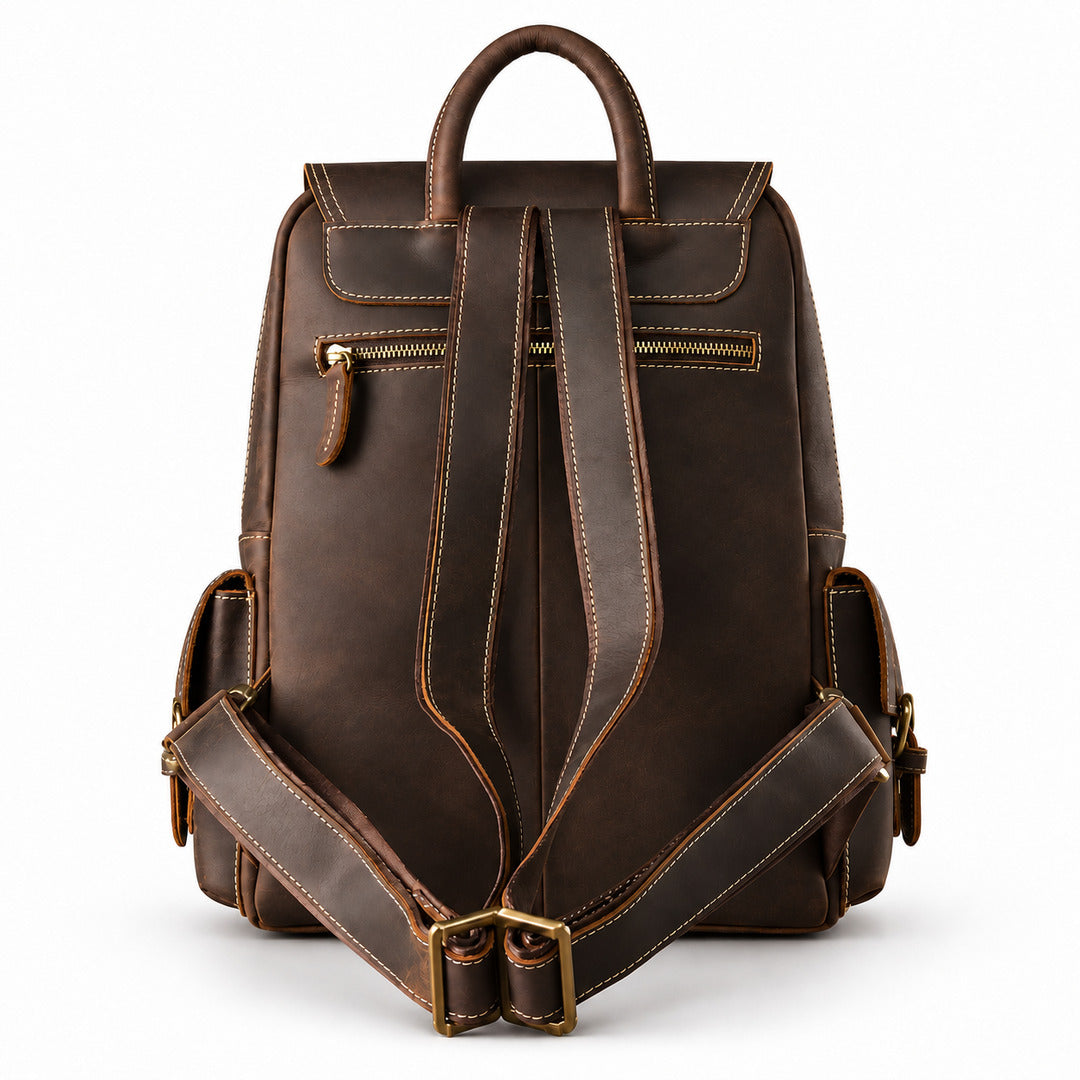 Back of a brown leather backpack showing both shoulder straps, carry handle and rear zip pocket.