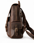A dark brown leather crossbody bag with a front flap pocket featuring a buckle closure.