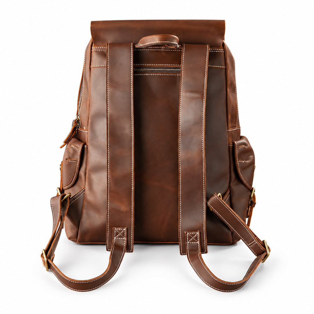 A brown leather backpack shown from the back, featuring dual padded shoulder straps, side pockets, and contrast stitching.