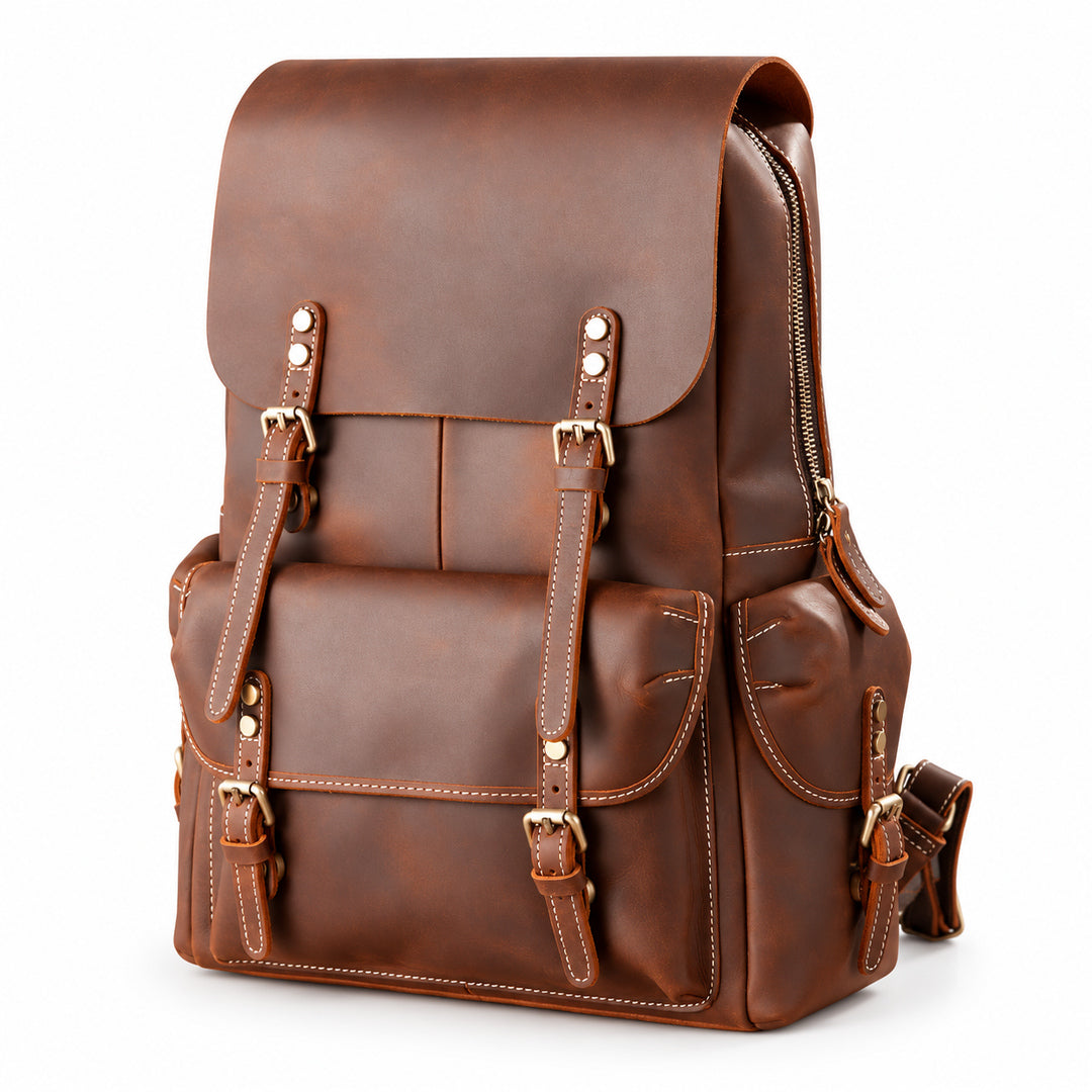 A brown leather backpack with a front flap, buckle straps, and multiple pockets, photographed.