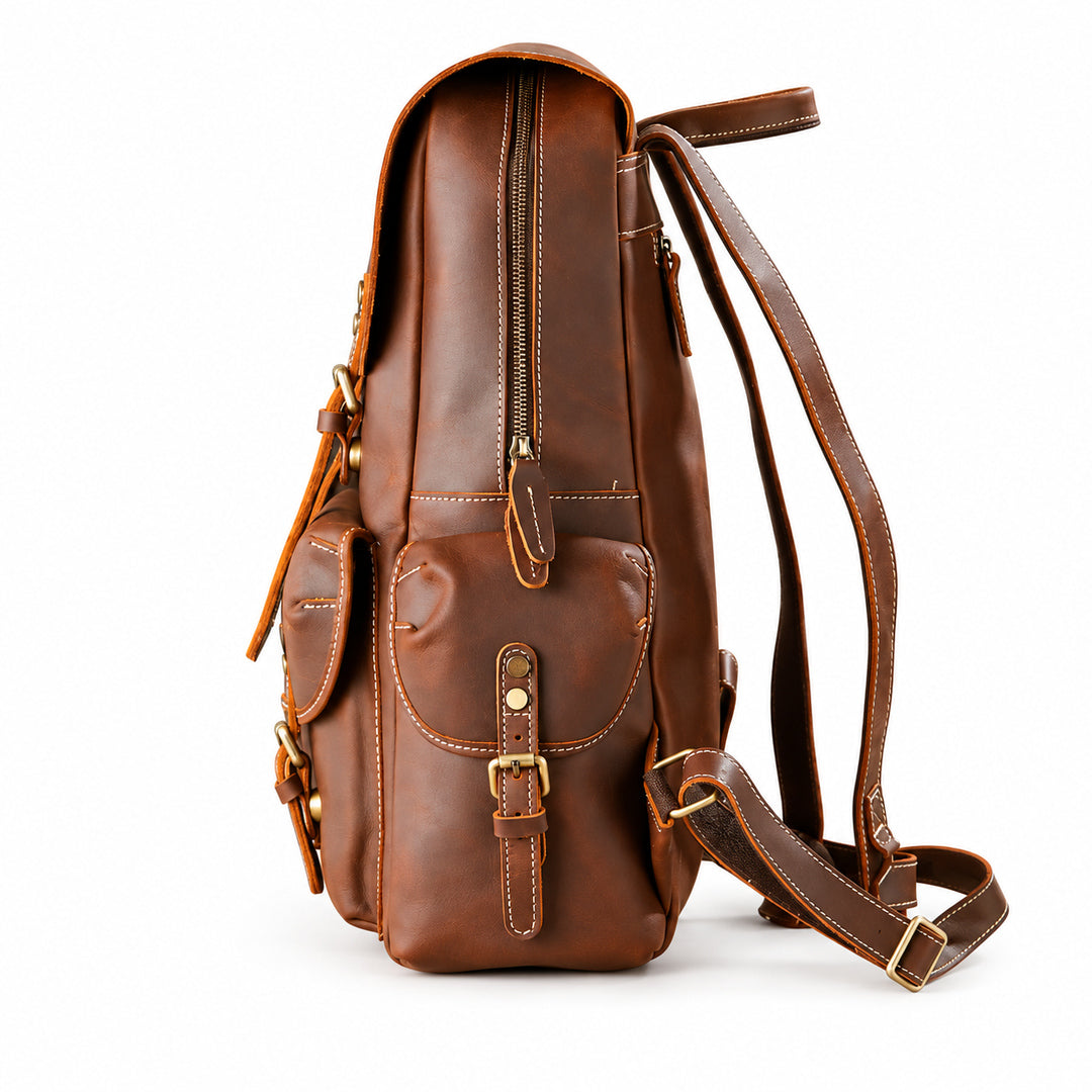 A brown leather backpack with a front flap pocket, zipper compartments, and adjustable shoulder straps.
