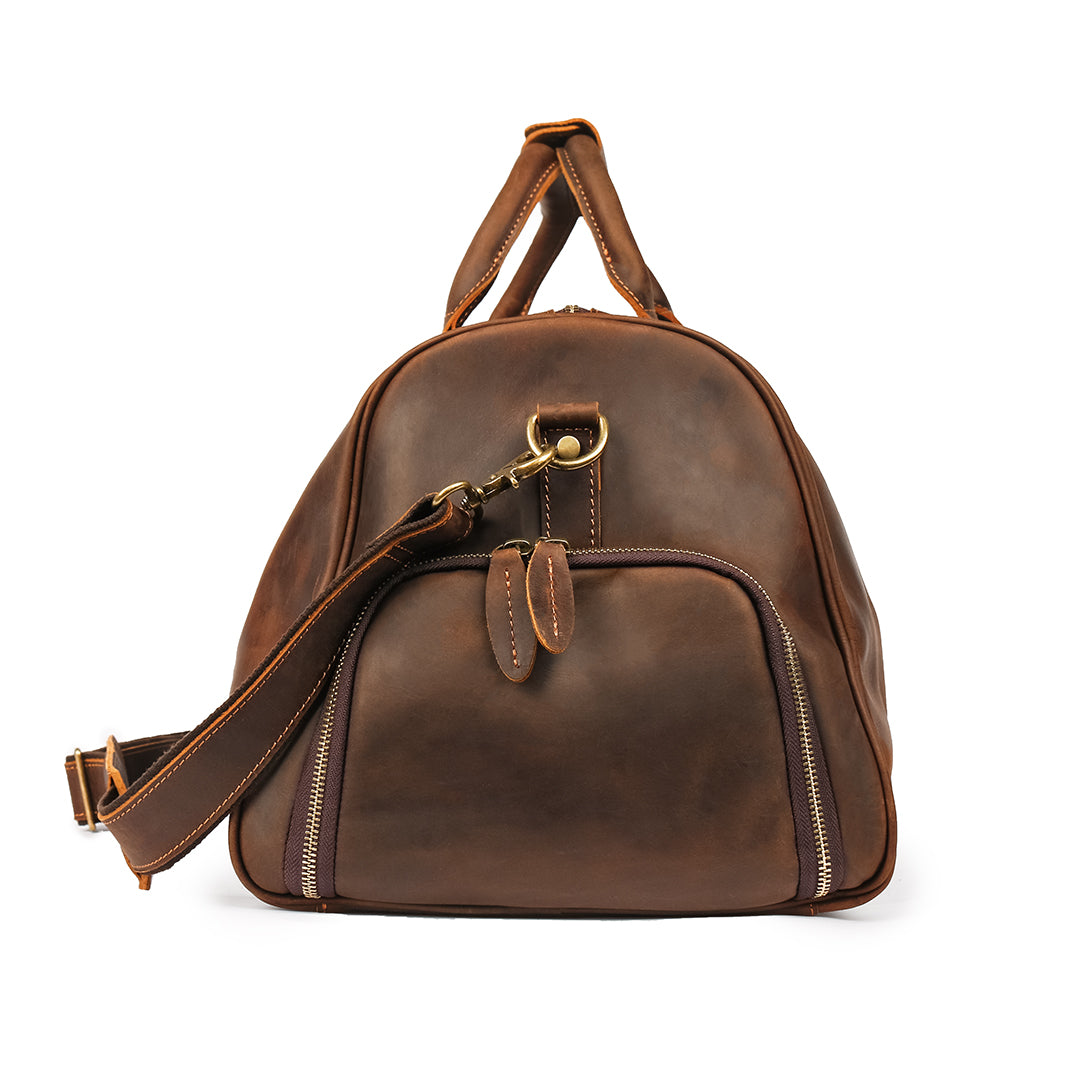 End view of a durable brown leather travel bag showcasing reinforced stitching and high-quality zippers.