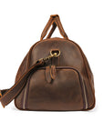 End view of a durable brown leather travel bag showcasing reinforced stitching and high-quality zippers.