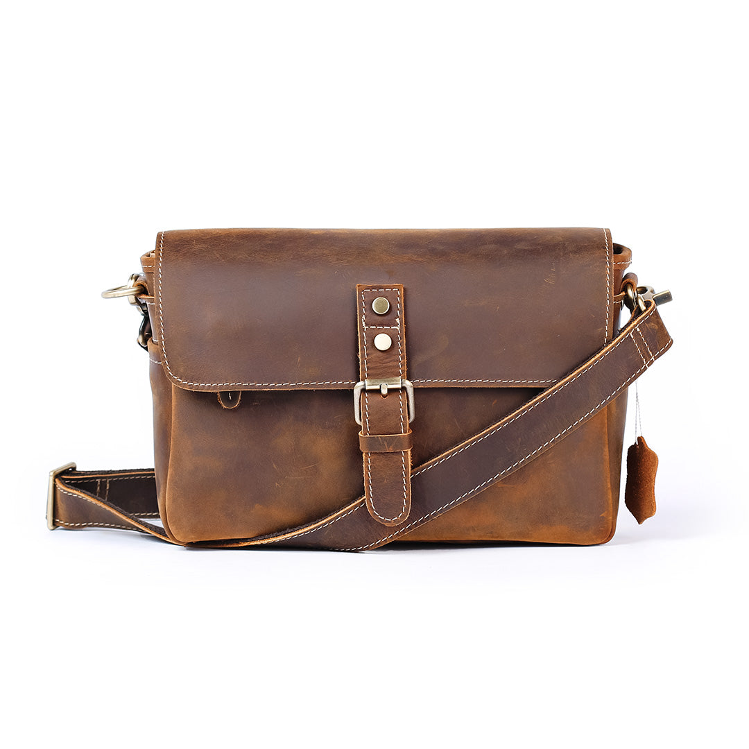 Brown leather satchel bag on a white background