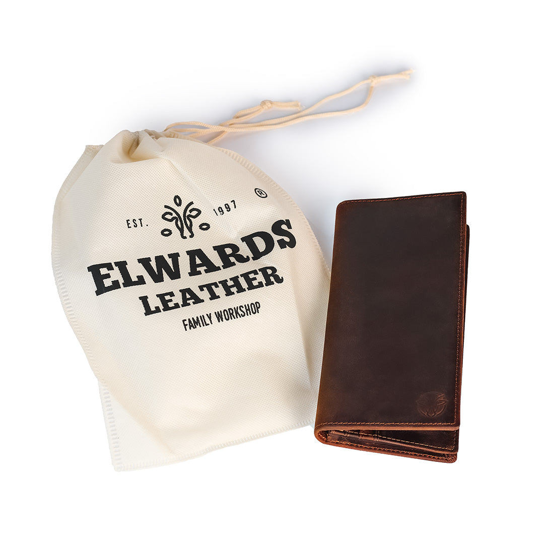 Brown leather wallet with Elwards Leather branded drawstring bag on a white background