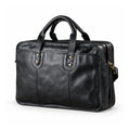 A black leather briefcase is shown in a front three-quarter view with rounded handles, paired brass-tone rivets and two zip compartments.