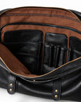 The black leather briefcase opens to reveal brown lining and a black leather organizer with pockets, card slots and two pen loops.
