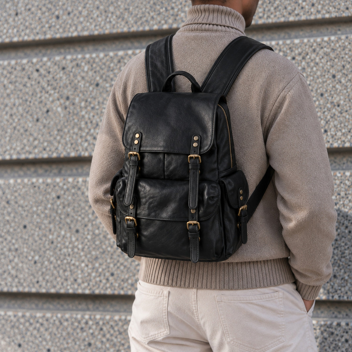 Classic black leather backpack for men with flap top, buckle straps, large front pocket and side pockets