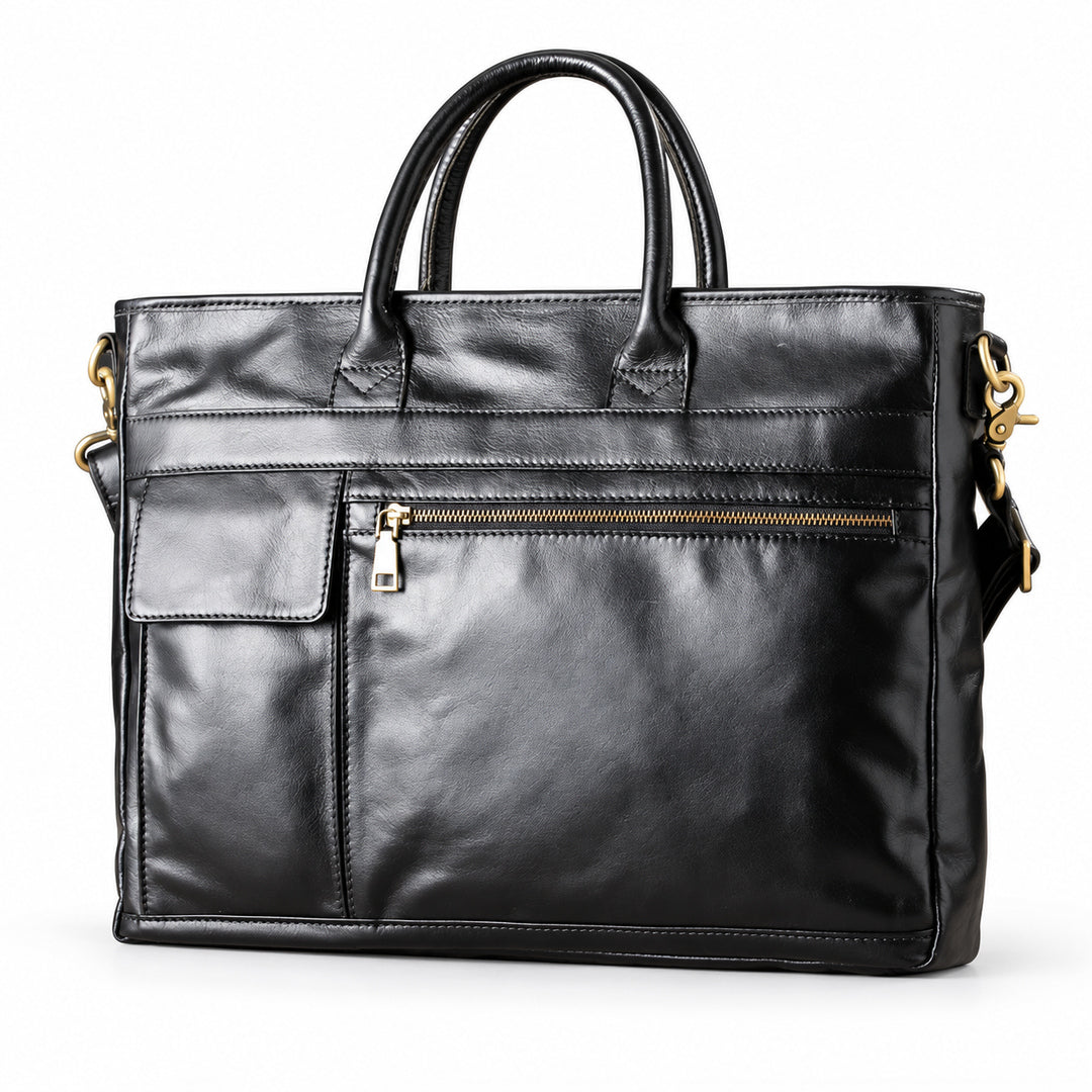Classic black full-grain leather briefcase at an angle showing front pockets and gold-tone hardware