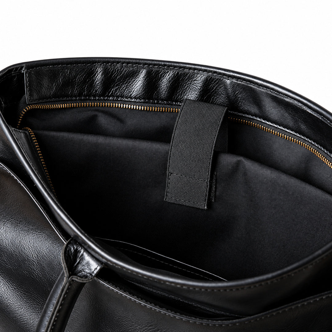 Classic black full-grain leather briefcase inner sleeve with a retaining strap and black lining