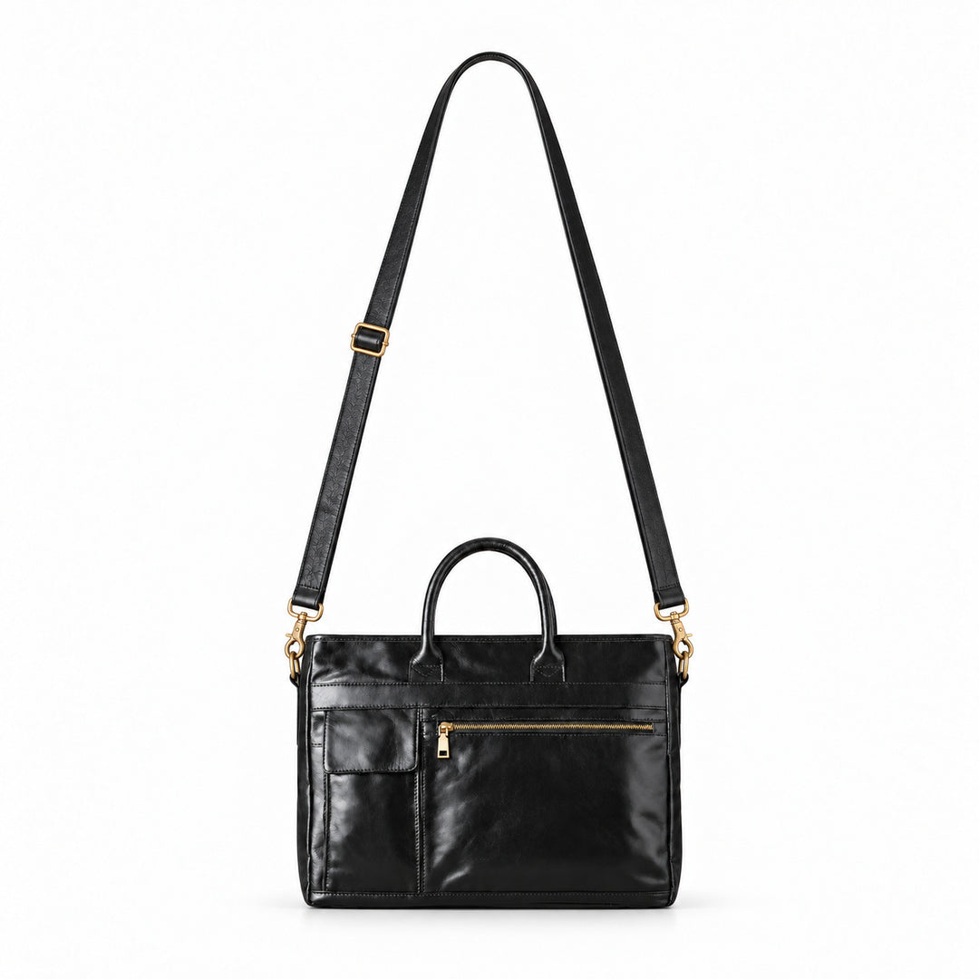 Classic black full-grain leather briefcase with raised detachable shoulder strap and gold-tone swivel clasps.